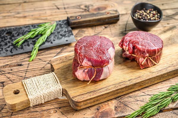 Raw fresh marbled meat Steak fillet mignon. Wooden background. Top view