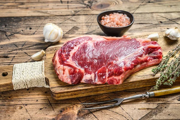 Rib eye or cowboy steak. Raw Marble beef black Angus, ribeye. wooden background. Top view — Stock Photo, Image