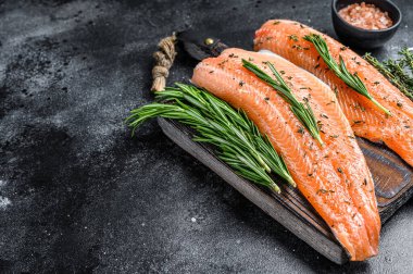 Tuzlu somon ya da baharatlı ve otlu alabalık filetosu. Siyah ahşap arka plan. Üst Manzara. Boşluğu kopyala