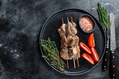 Şiş kebaplar bir tabakta ızgara et ve sebze. Siyah arka plan. Üst Manzara. Boşluğu kopyala