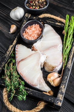 Tahta tepside otlu köpekbalığı eti. Siyah ahşap arka plan. Üst Manzara. Boşluğu kopyala.