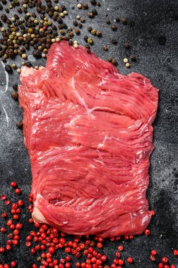 Siyah ve pembe biberli çiğ etekli biftek. Siyah arka plan. Üst görünüm