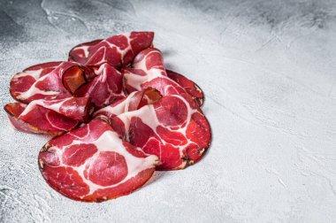 Coppa Cured ham on kitchen table. White background. Top view. Copy space clipart