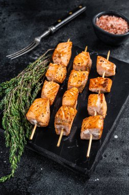 Mermer tahtada kızarmış somon kebabı şiş. Siyah arka plan. Üst Görünüm