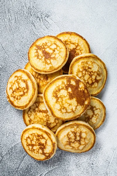 Tumpukan pancake mentega di meja dapur. Latar belakang putih. Tampilan Atas — Stok Foto
