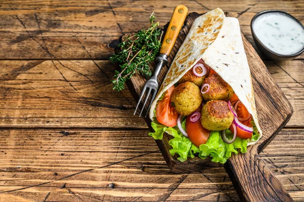 Vegetarische Tortilla wrap met falafel en verse salade, veganistische taco 's. houten achtergrond. Bovenaanzicht. Kopieerruimte — Stockfoto