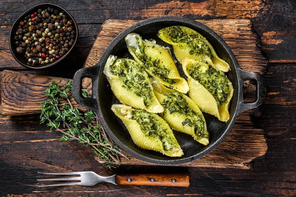 Jumbo conchiglie pasta italiana Conchiglioni konkiloni ripieni di carne di manzo e spinaci. Sfondo in legno scuro. Vista dall'alto — Foto Stock