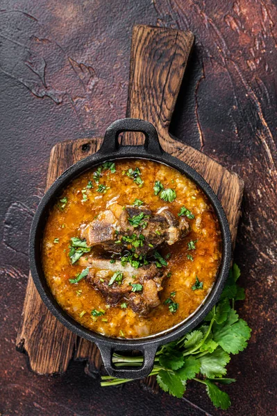 Kharcho soup with lamb meat, rice, tomatoes, carrots, peppers, walnuts and spices. Dark background. Top view — Stock Photo, Image