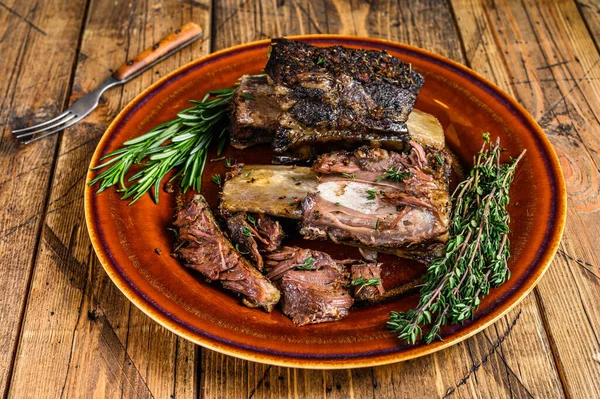 Costolette di manzo corte alla griglia con timo su un piatto rustico. sfondo in legno. Vista dall'alto — Foto Stock