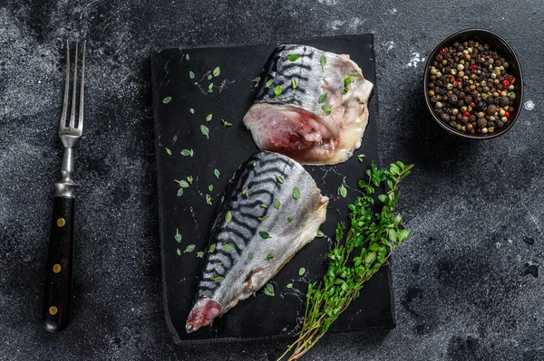 Cold smoked mackerel fish with herbs. Black background. Top view — Stock Photo, Image