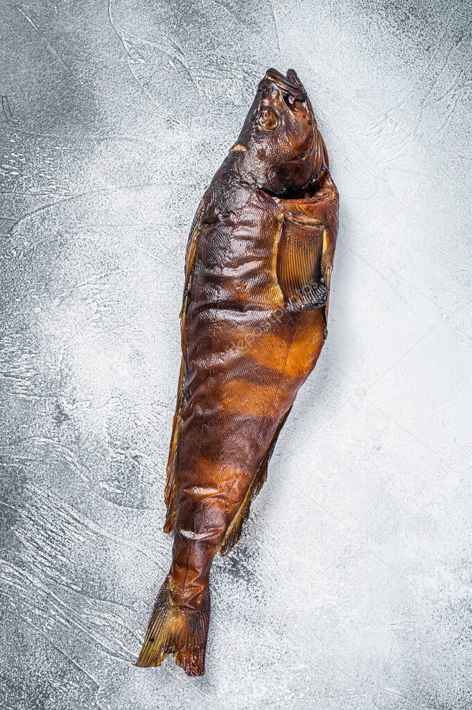 Hot smoked whole fish on kitchen table. White background. Top view