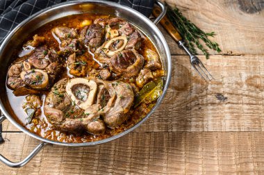 Dana budu, Osso Buco, İtalyan ossobuco bifteği. Ahşap arka plan. Üst Manzara. Boşluğu kopyala