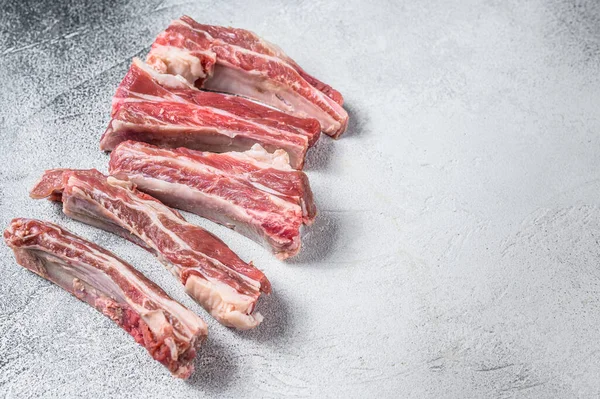 Raw sliced veal spare loin ribs. White background. Top view. Copy space — Stock Photo, Image