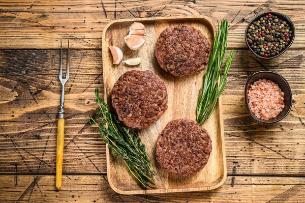 Barbecue Grilled ground beef steak patties, Mince meat on a wooden tray. wooden background. Top view