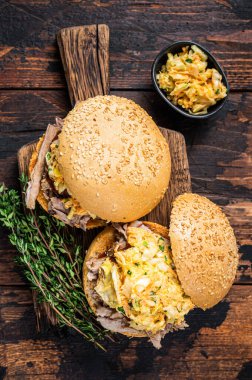 bbq soslu domuz burger ve lahana salatası. Koyu ahşap arka plan. Üst görünüm