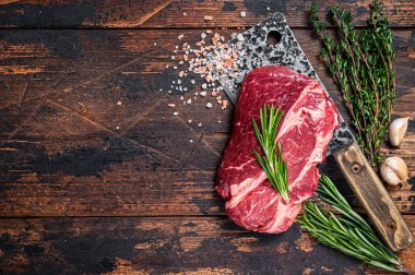 Çiğ Chuck 'ın gözü kasap satırında Black Angus bifteği. Koyu ahşap arka plan. Üst Manzara. Boşluğu kopyala