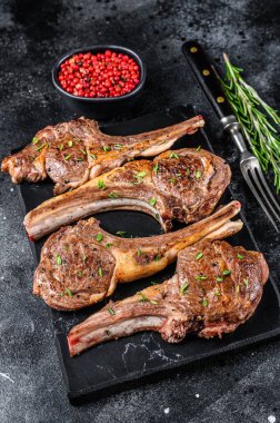 Misket tahtasında ızgara kuzu pirzolası. Siyah arka plan. Üst görünüm