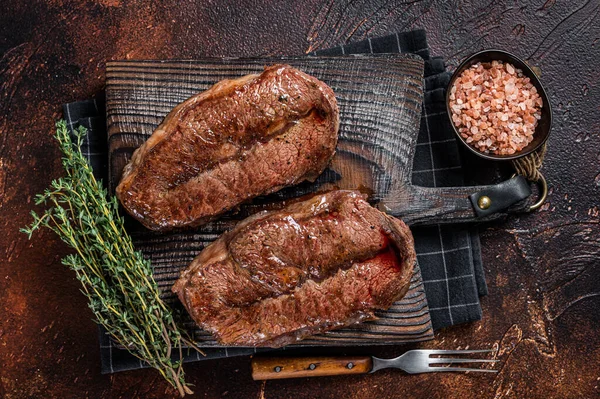 BBQ roasted Shoulder Top Blade cut or Australia wagyu oyster blade beef steak. Dark background. Top View