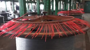 Kablo yapma makinesi. Üretim ekipmanlarının parçaları dönüyor. Eski fabrika.