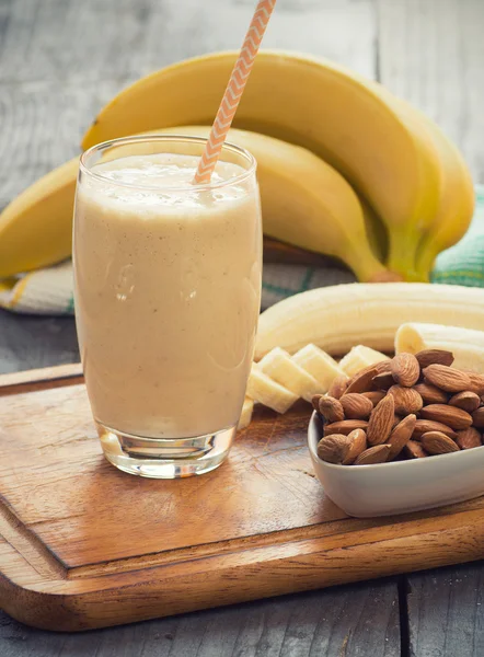 Fresh made Banana smoothie on wooden background — Stock Photo, Image