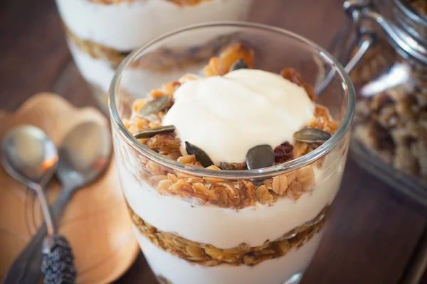 Healthy Breakfast - yogurt with homemade granola on the bright wooden board — Stock Photo, Image