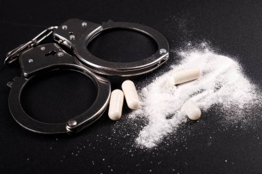 handcuffs and cocaine closeup, drug control arrest clipart