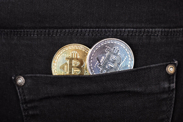 gold and silver bitcoins in your pocket closeup.rise in the value of cryptocurrencies