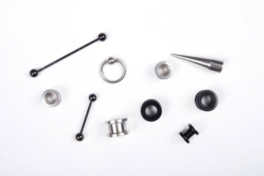 set of piercing accessories on white background