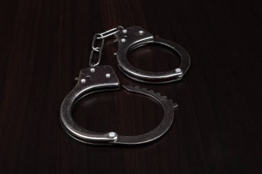 handcuffs on a dark background closeup