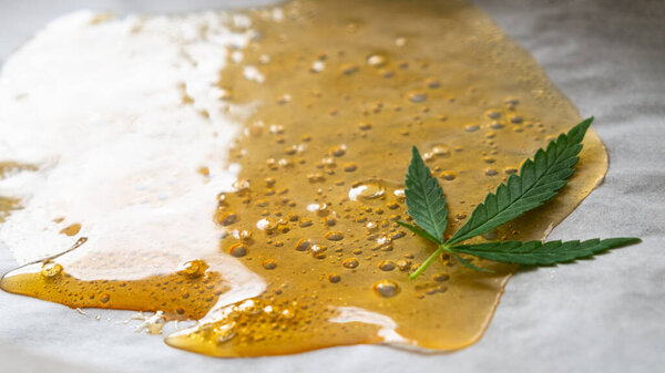 strong extract of gold cannabis wax with high thc close up.