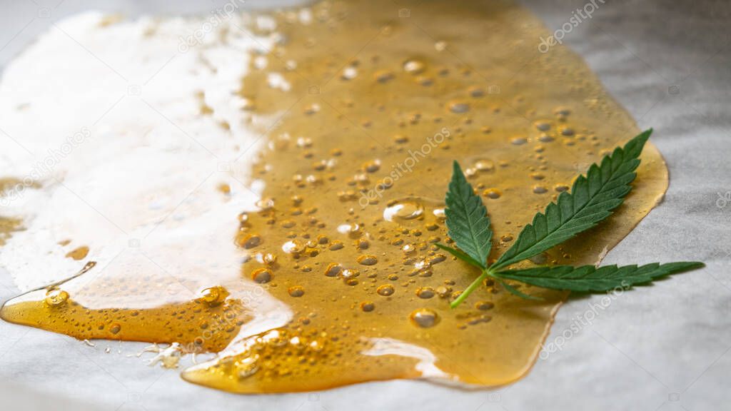 strong extract of gold cannabis wax with high thc close up.