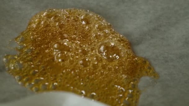 Liquid resin wax concentrate from cannabis on parchment paper. high thc — Vídeos de Stock