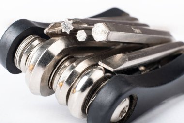 black multitool with screwdriver and hex wrenches for bicycle closeup