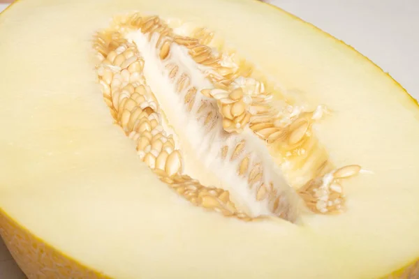 yellow ripe melon cut in half close-up, seasonal berry