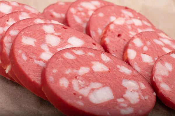 Sliced uncooked smoked sausage close up, sausage for sandwiches — Stock Photo, Image