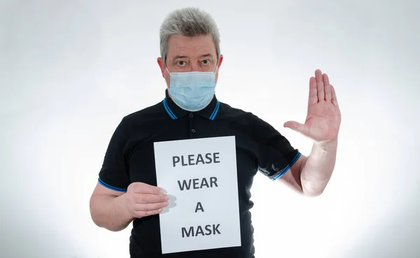 Man Wearing Medical Mask Holds Sign Phrase Please Wear Mask — Stock Photo, Image