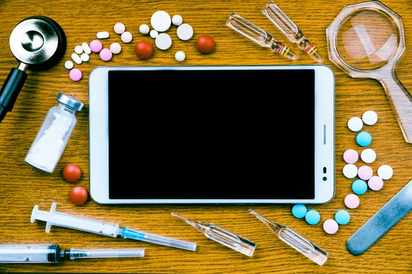 Tablet pc with medical objects on a desk