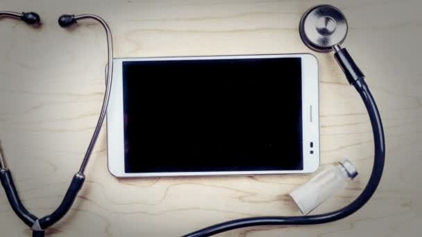 Tablet pc with medical objects on a desk — Stock Video