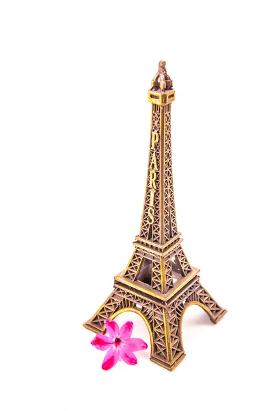 Model of little Eiffel Tower with a pink flower — Stock Photo, Image