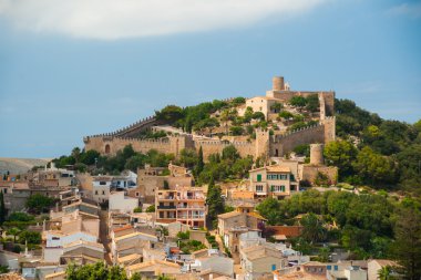 Capdepera castle on green hill in Mallorca clipart