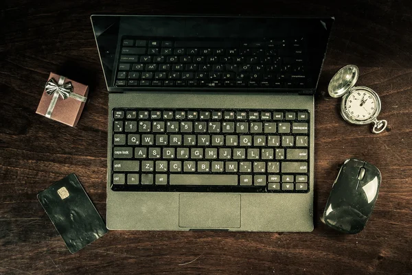 black laptop on wood