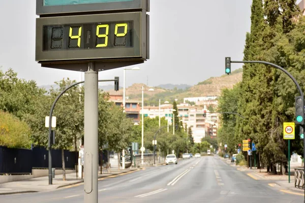 Street thermometer on a street marking 49 degrees celsius in summer