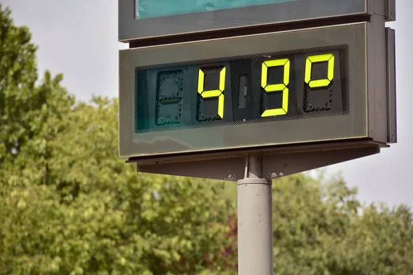 Street thermometer on a street marking 49 degrees celsius in summer