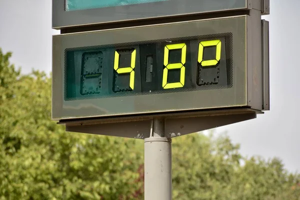 Street thermometer on a street marking 48 degrees celsius in summer