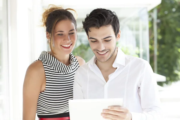 Young gorgeous couple with tablet computer — Stock Photo, Image