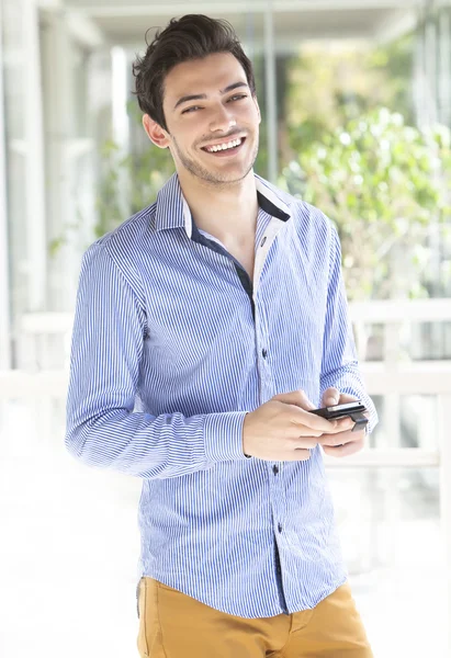 Young man using smart phone — Stock Photo, Image
