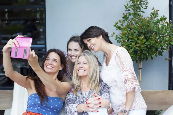 Grupo de amigos tomando fotos con un smartphone al aire libre — Foto de Stock