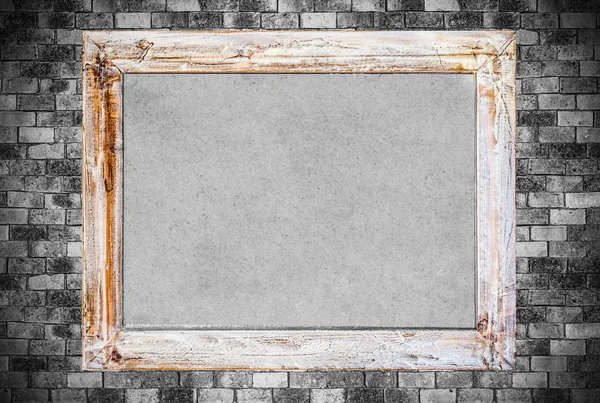 Vintage wooden frame on old brick wall background.