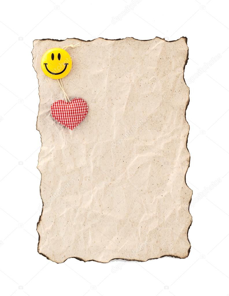 Burned edges paper with heart and smile. Isolated on white.