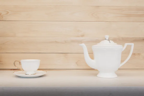 Чашка чая с чайником на деревянном фоне . — стоковое фото